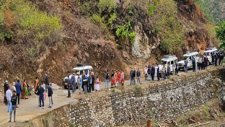 Wedding procession stuck in debris on the road in bageshwar