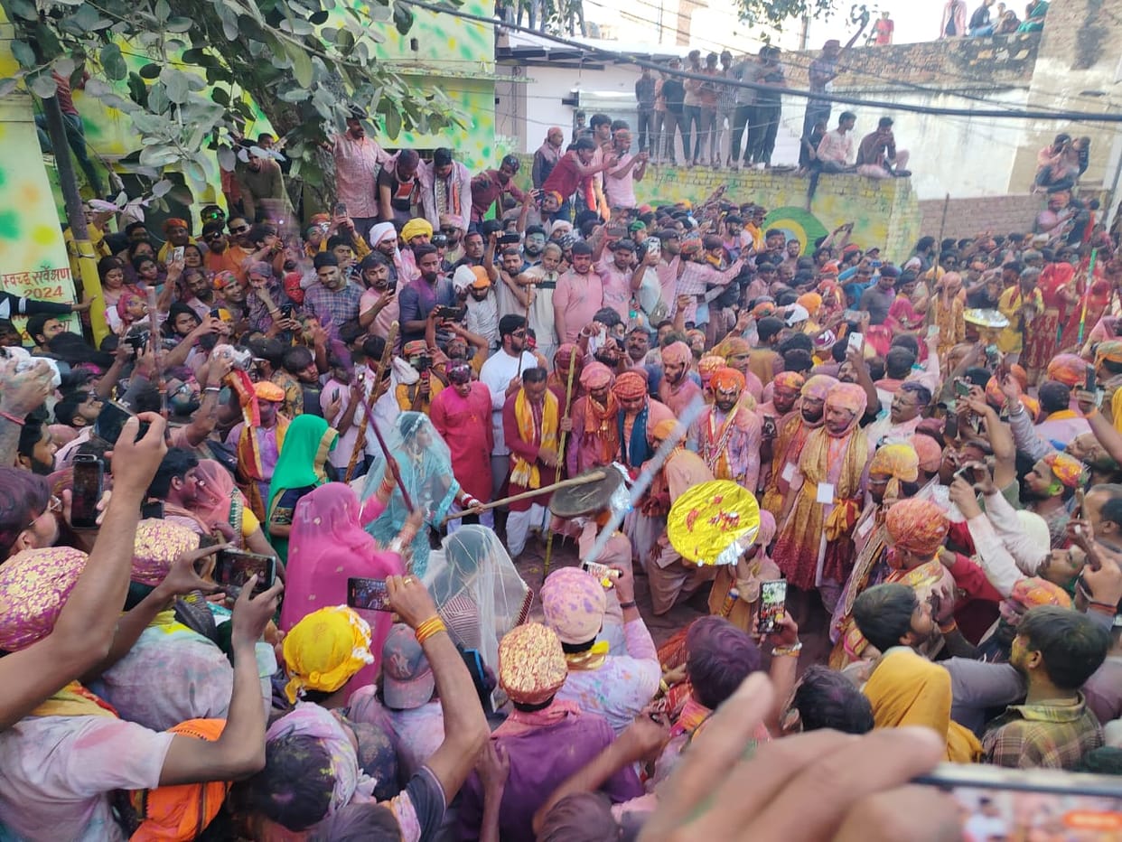 Lathmar Holi of Barsana Huriyarins showered sticks Huriyars act of protecting themselves
