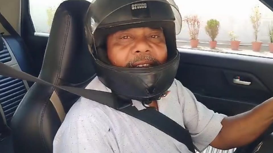 Bijnor man driving his car in wearing a helmet due to fear of challan