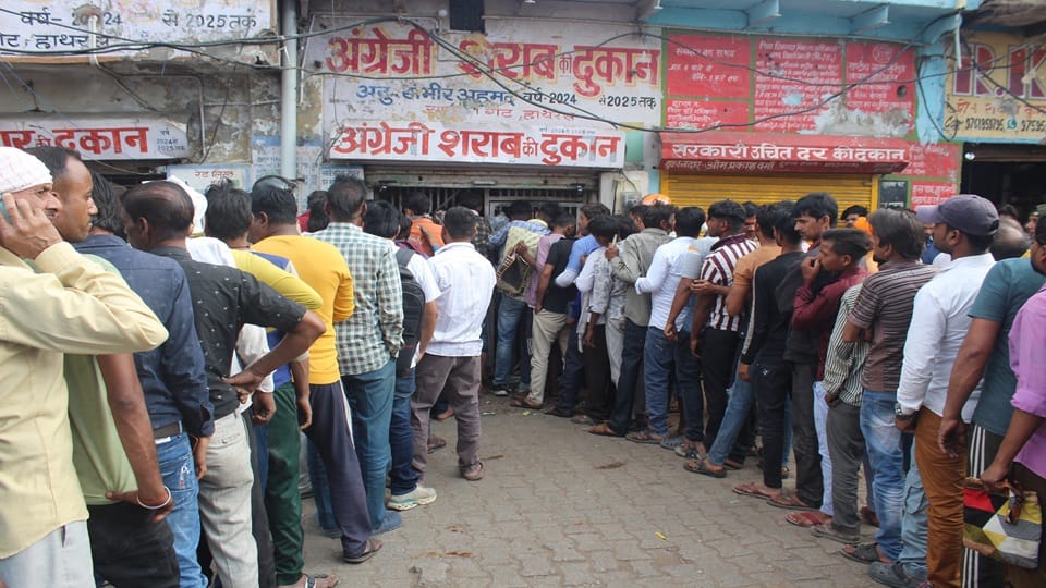 Crowds gathered at liquor shops, queues formed