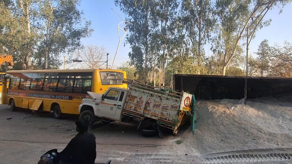 A truck collided with a school bus and a car, one woman died and three people were injured