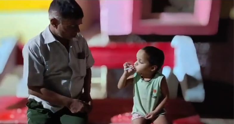 Cigarette scandal of government doctor goes viral in jalaun  taught a small child to inhale smoke