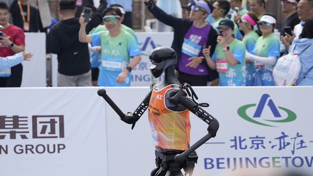 China held the world's first marathon of humanoid robots running together with human runners