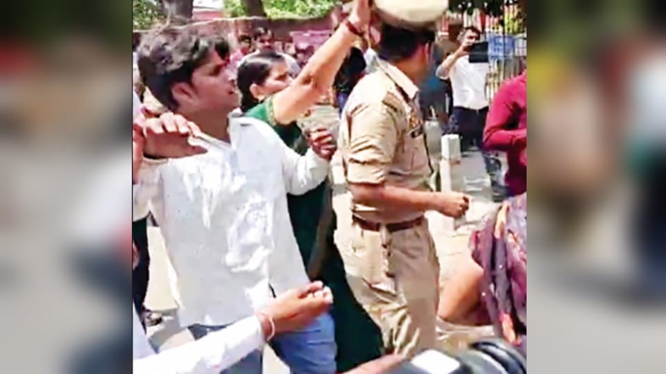 misbehaved with the police after stopping from burning Mamata Banerjee's effigy in Meerut. Inspector cap throw