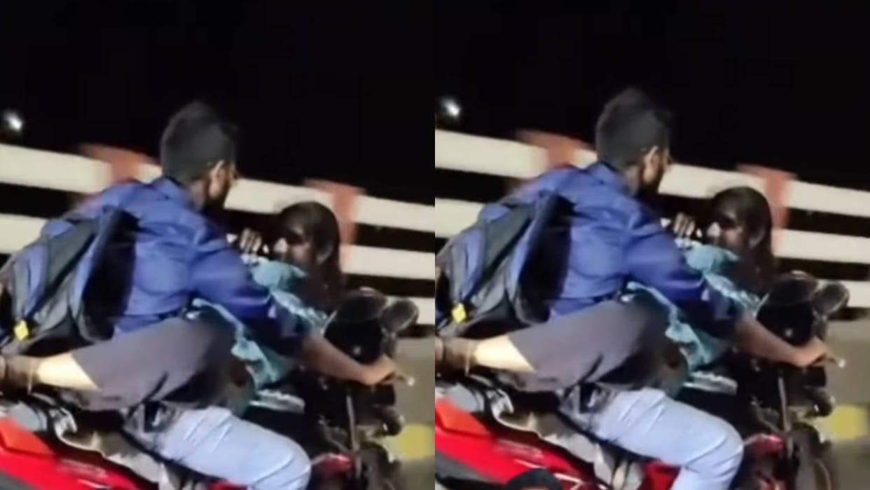 The boy was riding the bike with his girlfriend lying on tank risking his life Video goes viral on Internet