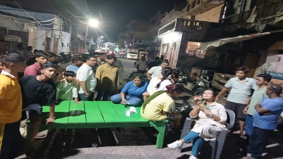 woman sat on a dharna outside her maternal home for property