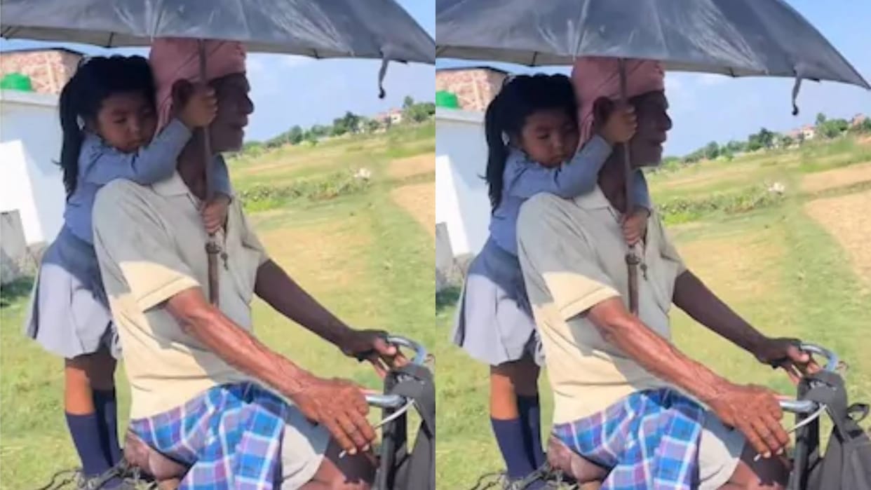 Father was riding a bicycle in scorching sun and a little girl was standing with an umbrella video goes viral