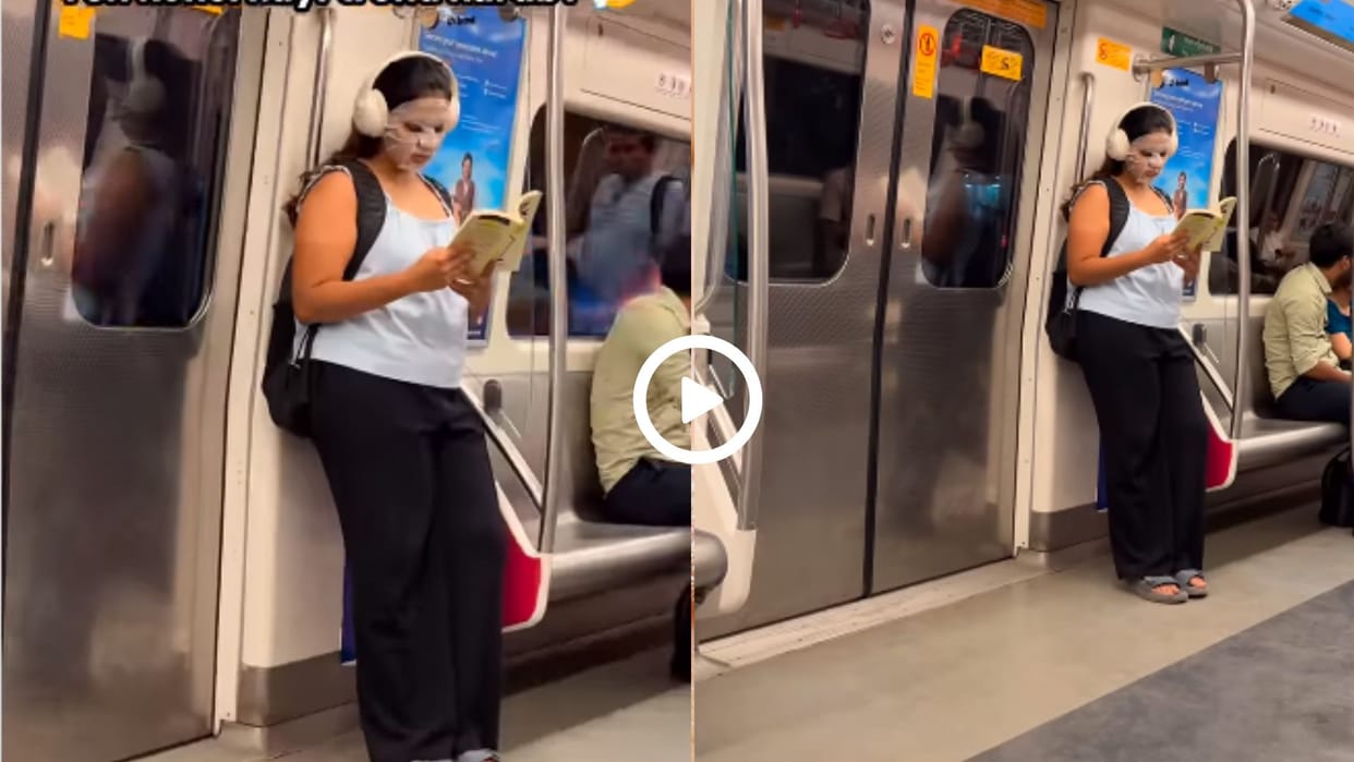 Video of a girl reading a book at the delhi metro gate wearing a face mask went viral