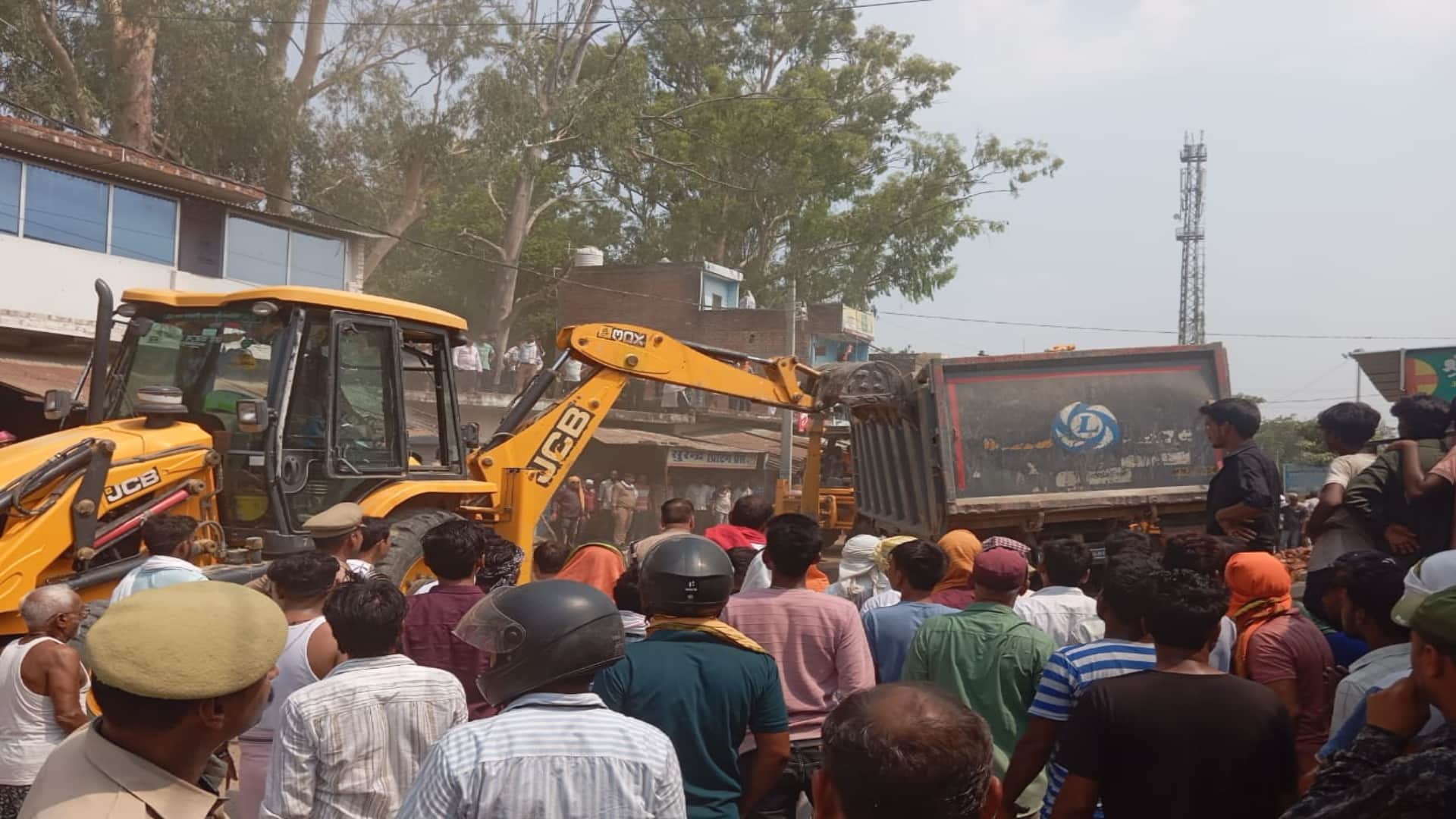 Sand laden dumper overturns on a tempo full of passengers, several people reported dead