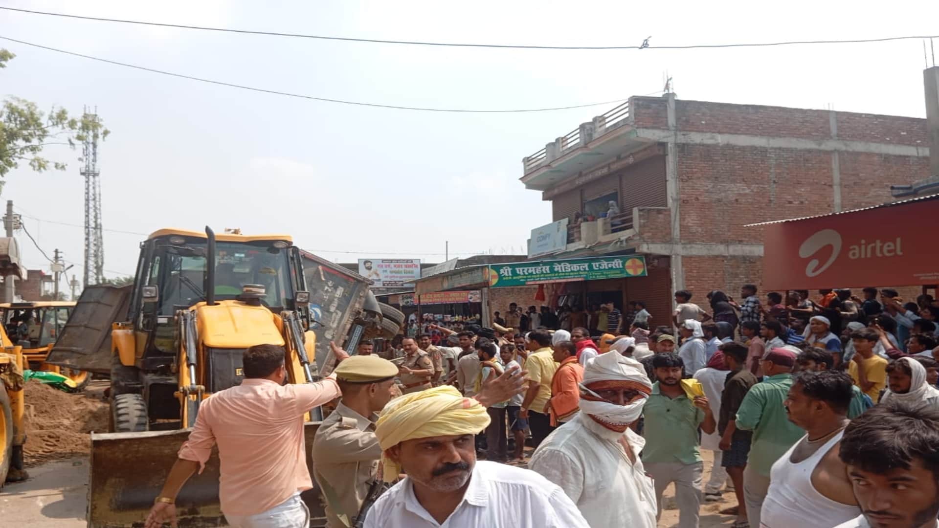 Sand laden dumper overturns on a tempo full of passengers, several people reported dead