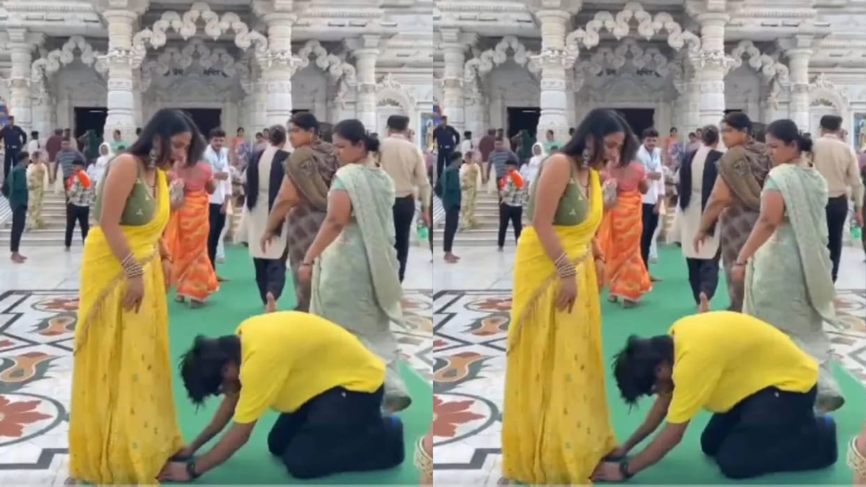The boy was making reel by touching his wifes feet outside the temple the grandmother scolded him Video Viral