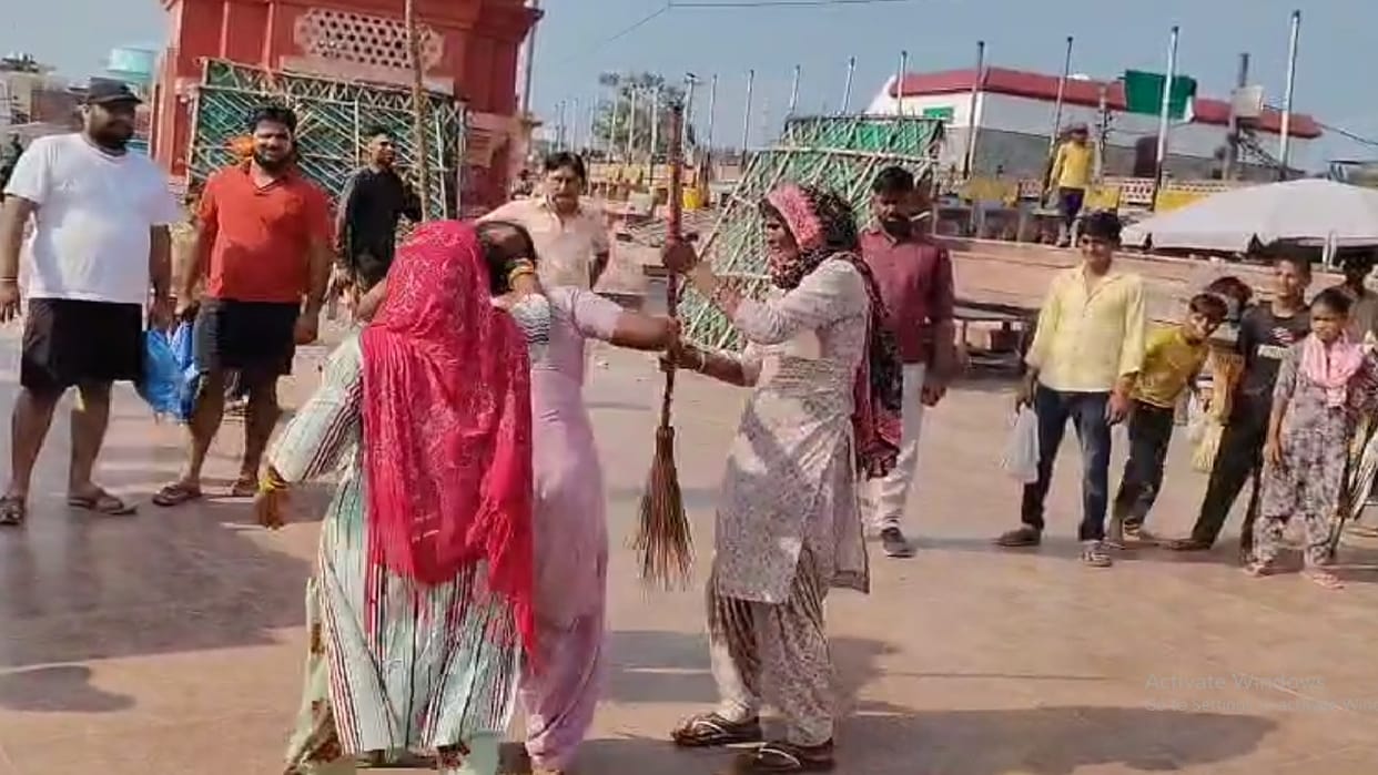 Women fight with brooms on banks of Ganga in Hapur