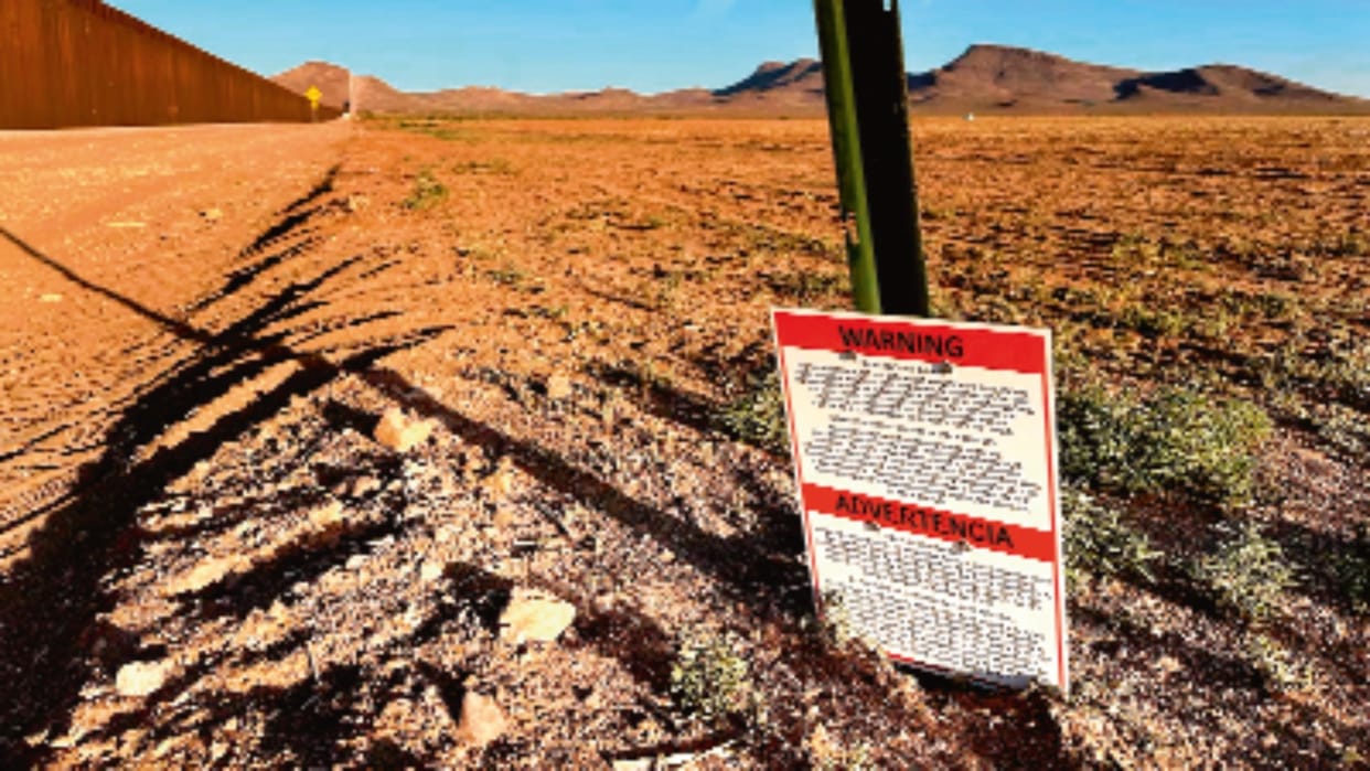 US military posted orange no entry signs in English and Spanish in New Mexico desert