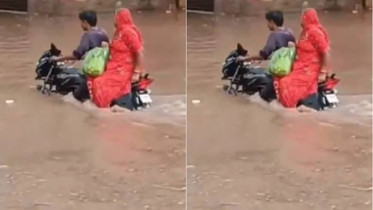 The road was filled with water boy was taking his mother on the bike then suddenly a Thar came Video Viral