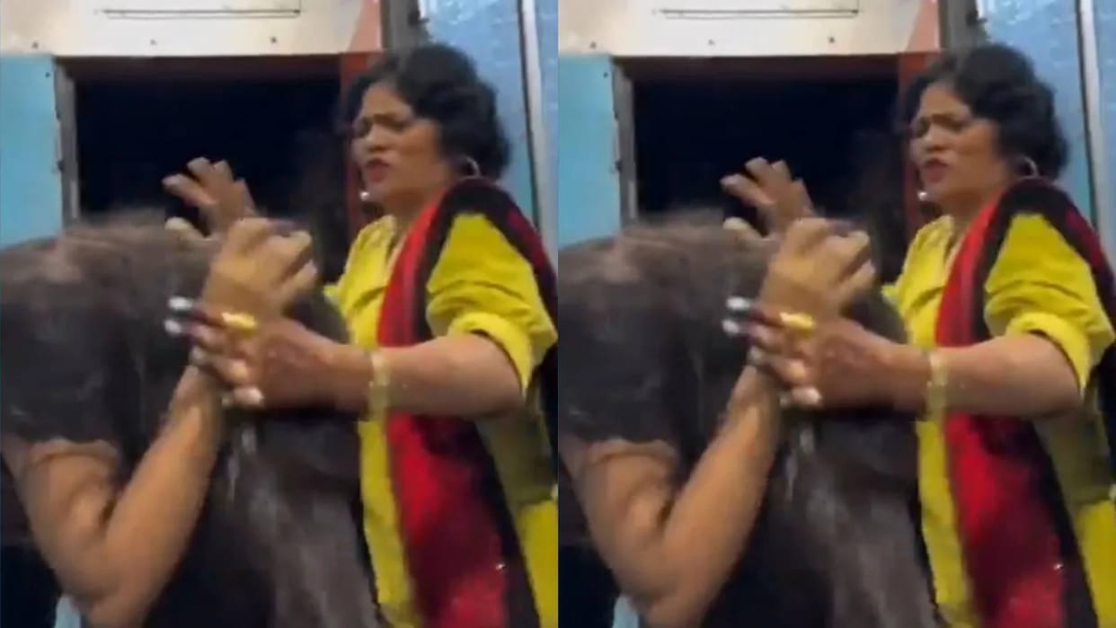 Girl was making a reel by hanging on the door of a moving train aunty slapped her Video goes Viral