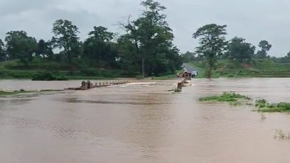 Kursa river water flowing over the bridge officials are not interested in filling the potholes in Balrampur Ra
