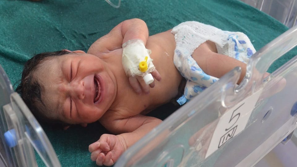 nurses shed tears while handing over the newborn