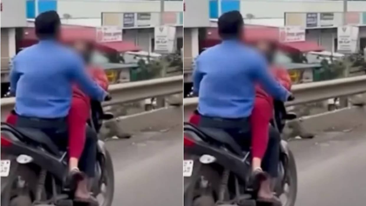 Girlfriend hugs boy while sitting on the tank of a bike breaking traffic rules Video goes Viral on Internet
