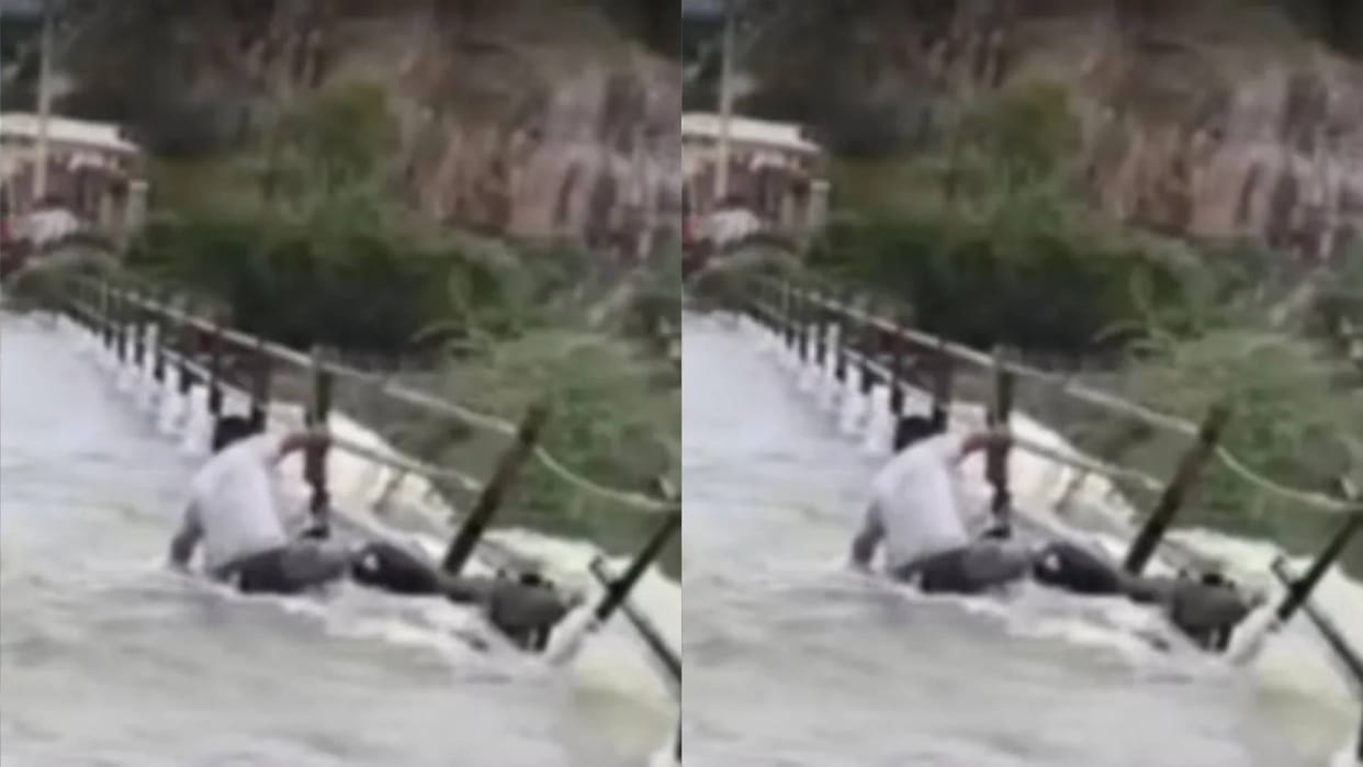 The river was overflowing and bridge was submerged the boy showed heroism and did a stunt Video Viral