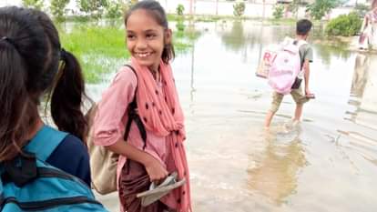 सोमवार को जलभराव से होकर स्कूल पहुंचे बच्चे