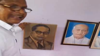 बाबा साहेब के चित्र को फिर से लगाते प्रधानाध्यापक