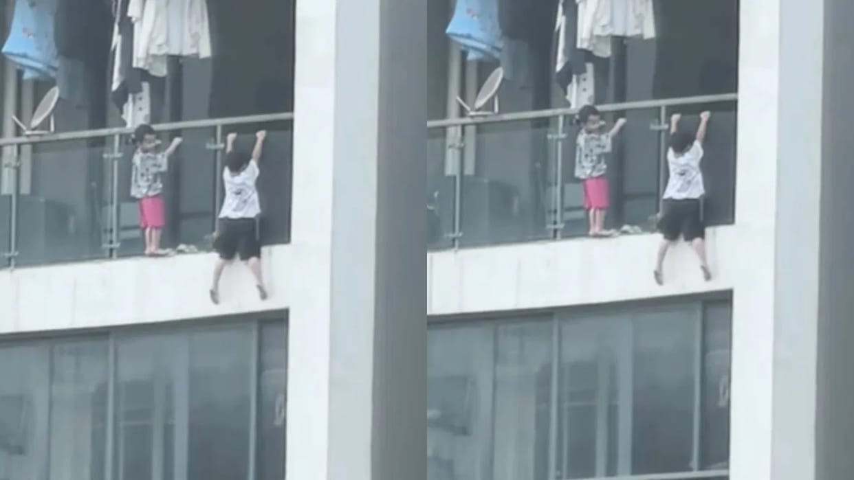 Two kids seen hanging from the 13th floor the boy was doing push ups Video goes Viral on Internet