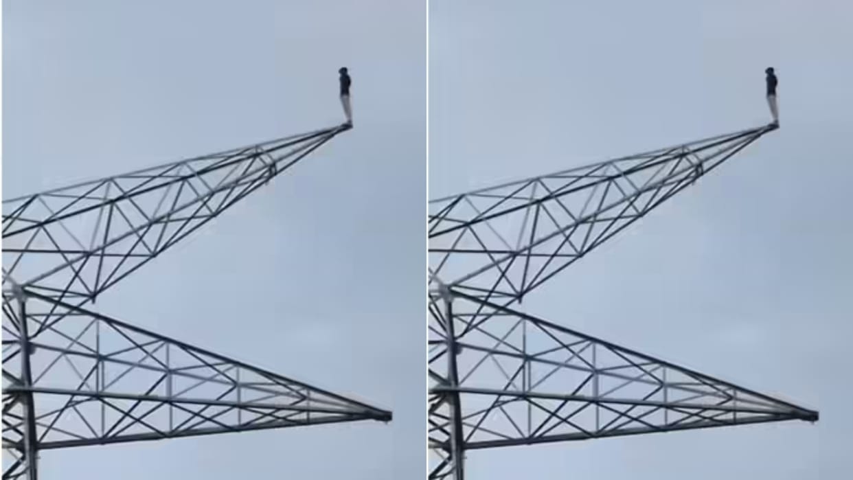 Dangerous drama of a lover climbed a high tension tower in his insistence for love marriage video went viral