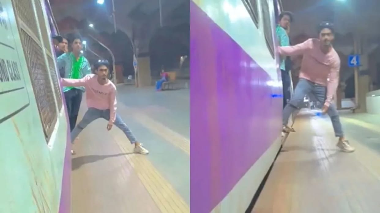A man was doing a dangerous stunt by hanging from a moving train pushed people at the station Video Viral