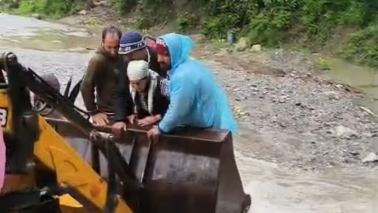 a pregnant woman to the hospital sitting on the bucket of a JCB Shimla Himachal Pradesh