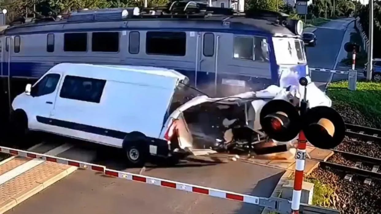 A man was crossing the railway tracks suddenly a train came and the car was blown to pieces Video Viral