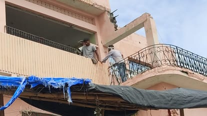 आवास तोड़ते मजदूर