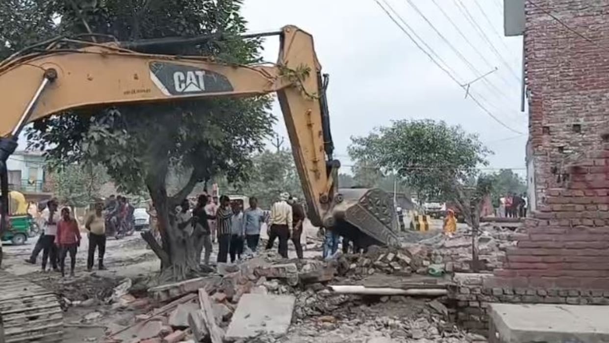 Bulldozer runs on encroachment obstructing the widening of the state highway in shahjahanpur
