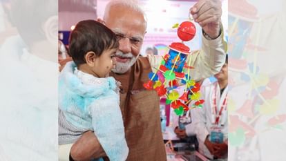 PM Narendra Modi Picks Up a Child at the Exhibition, Showers Him with a Toy and Pampers Him.
