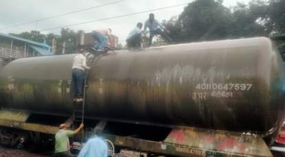 आग बुझने के बाद पेट्रोल भरे वैगन के ऊपर चढ़कर जांच करते रेल अधिकारी व कर्मचारी