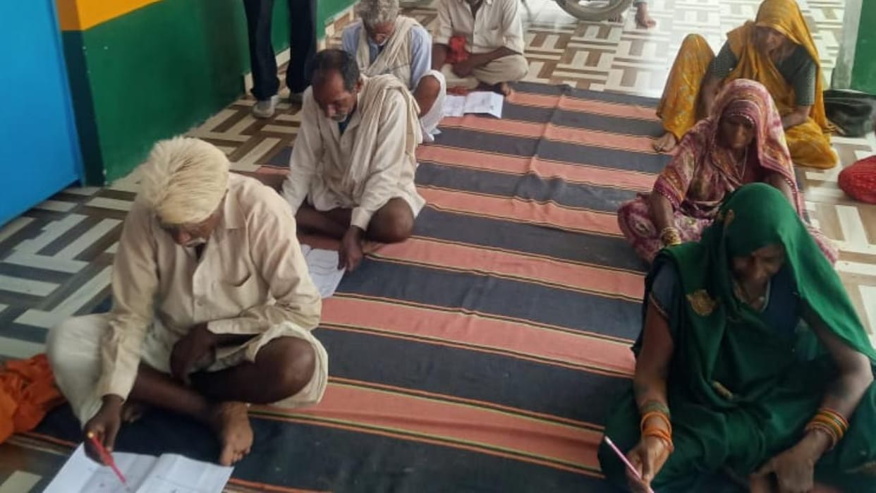 Literacy program: Grandparents took the exam holding pens and sticks.