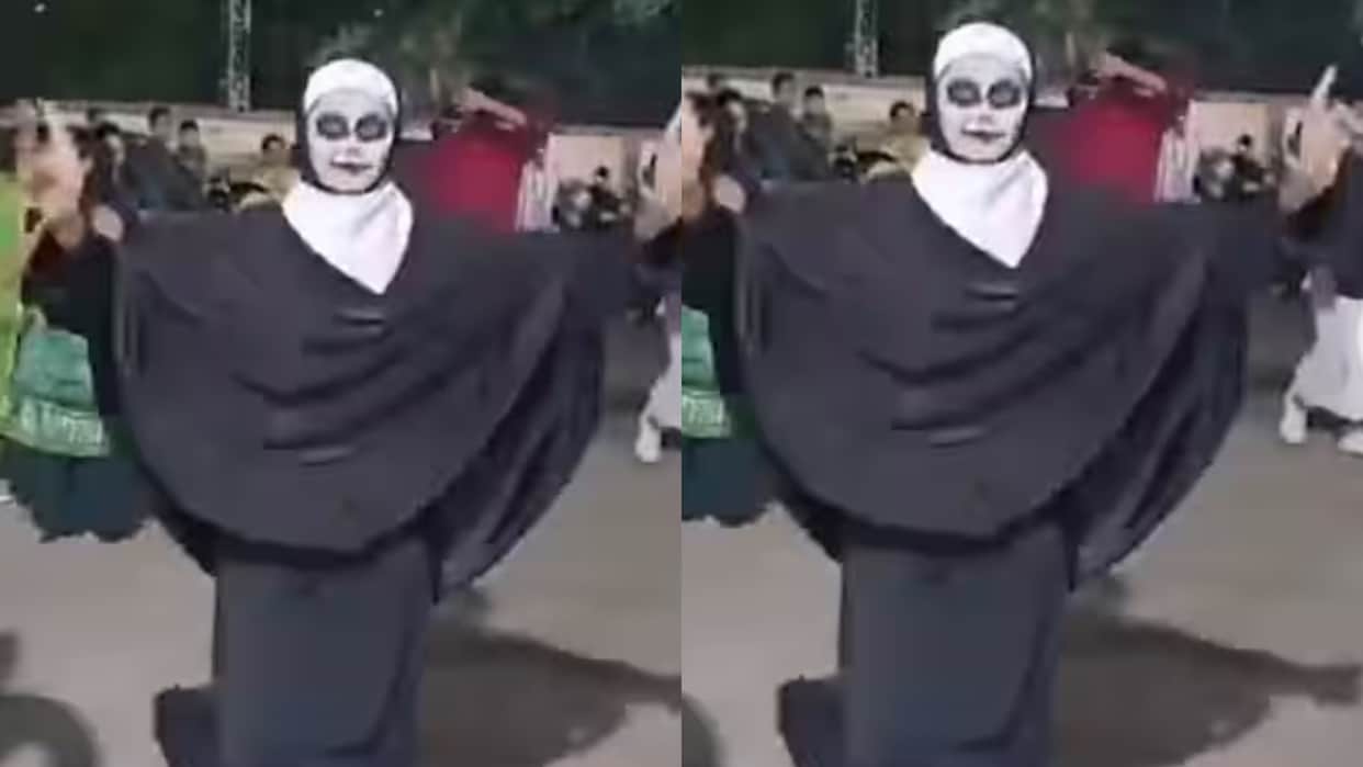 A woman wearing a burqa and witch like makeup arrived to play Garba enraging the crowd and scolding them