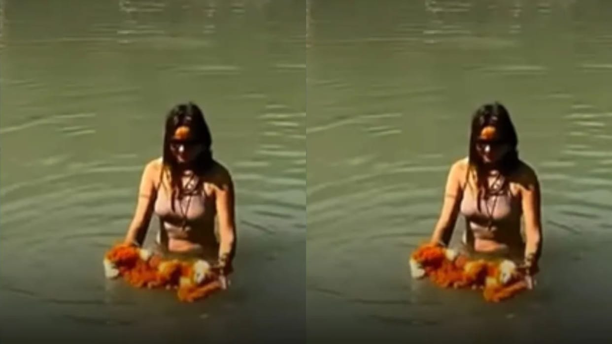 Foreign woman takes a dip in the Ganges wearing a bikini enraged people say she has torn apart the values