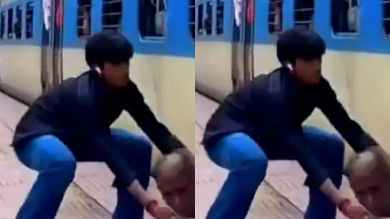 A boy was making a reel on the platform an elderly man getting off the train behind him slipped Video Viral