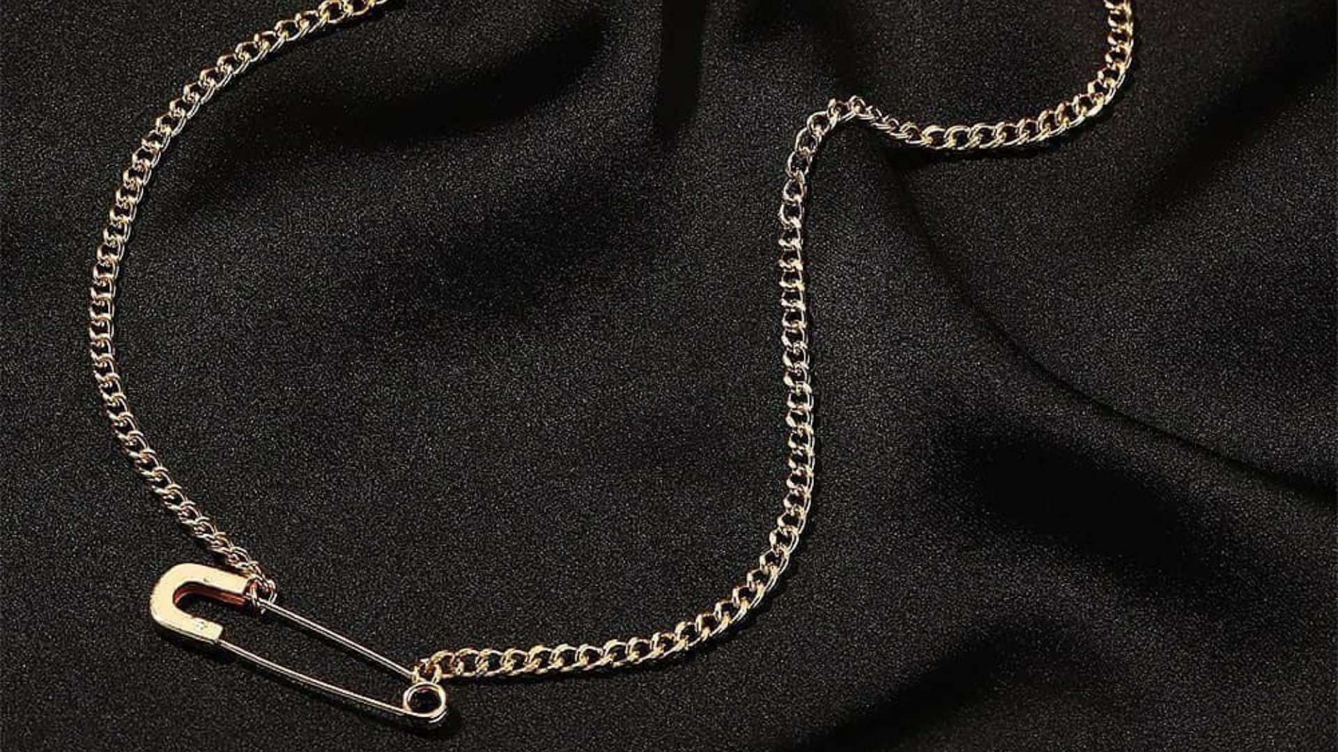 why young generation wear safety pin as necklace details behind safety pin accessory