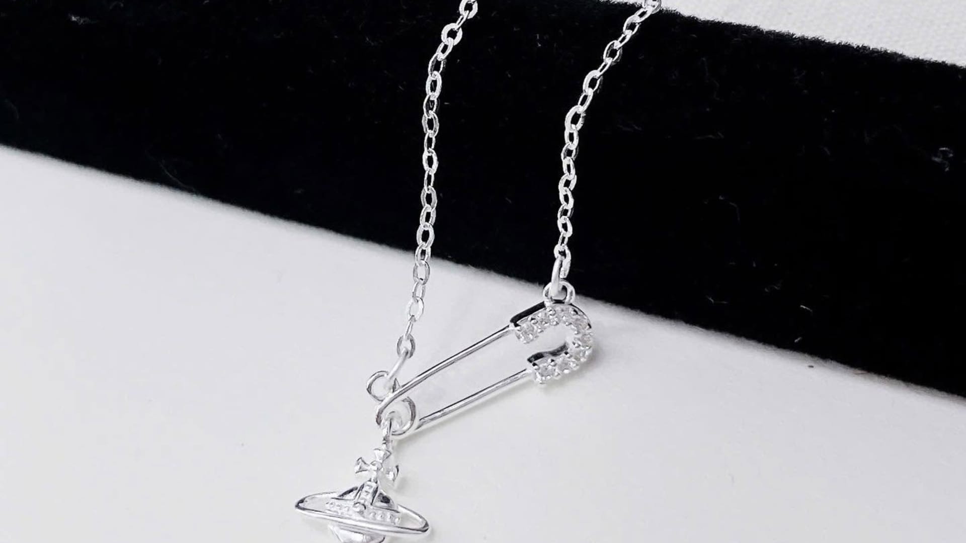 why young generation wear safety pin as necklace details behind safety pin accessory