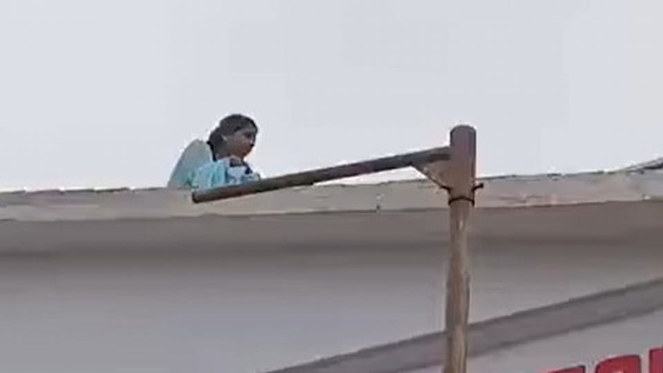 A student climbed onto the roof of a degree college carrying a bottle of petrol in sitarganj