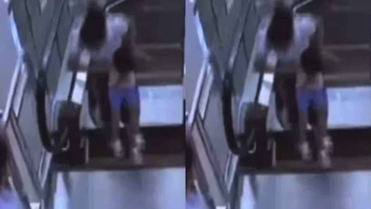 A woman fell down from an escalator carrying a child in her lap What happened next Video goes Viral