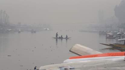 Shikaras were seen moving amidst the morning fog at the famous Dal Lake.