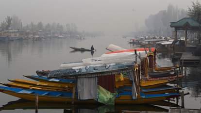 Shikaras were seen moving amidst the morning fog at the famous Dal Lake.