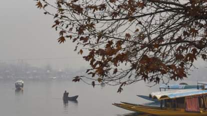 Shikaras were seen moving amidst the morning fog at the famous Dal Lake.