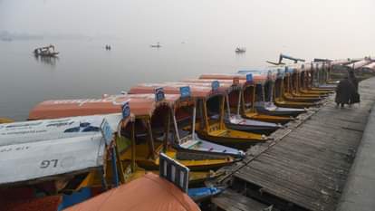 Shikaras were seen moving amidst the morning fog at the famous Dal Lake.