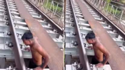 A young man performed a deadly stunt on a railway bridge hanging from the tracks and openly challenging death