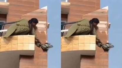 A woman was cleaning the edge of the balcony by holding the grill people were shocked Video goes Viral