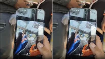 A woman was admiring the view from the window seat a man standing behind her was secretly taking pictures