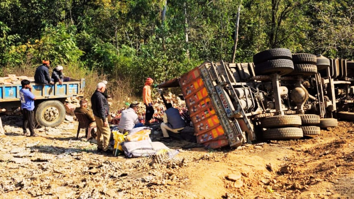Smuggling in Pushpa style Truck overturns in ditch sacks of rice contained lakhs worth of liquor